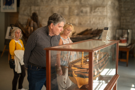 People looking at a boat on display