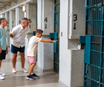 Family closely exploring Kingston Penitentiary jail cells Visit Kingston