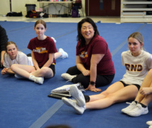 Sandy Han chats with members of the Regiopolis-Notre Dame cheerleading team.