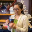 Kaoru holds a mug made by local potter Ikuko Hall. Cha Cha Tea carries a number of pieces by local artisans, as well as tea accessories